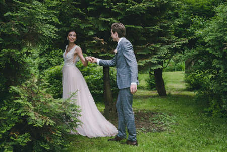 The girl leads the man in the woodsの写真素材