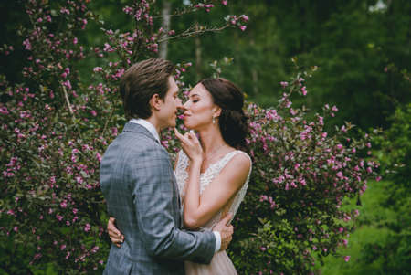 Bride and groom hugging in the parkの写真素材