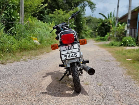 Songkhla, Thailand, October 10, 2021 - Kawasaki GTO Mach-4 Blue color on gravel road.