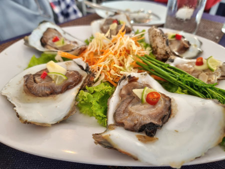 Fresh oysters with spicy, sweet and sour seafood sauce for party