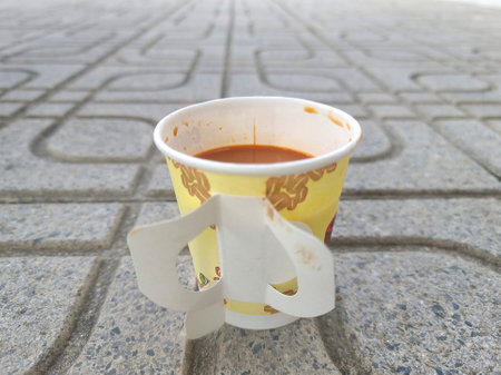 Hot coffee or hot tea in a paper cup is placed on the floor.の写真素材