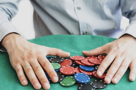 hands holding poker chipsの写真素材