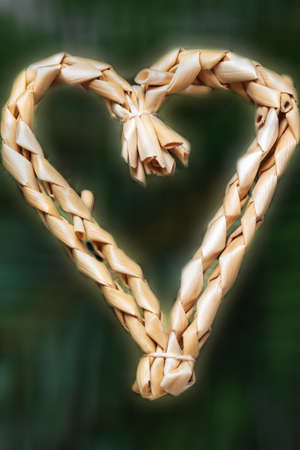 Straw heart for the Christmas tree, isolatedの写真素材
