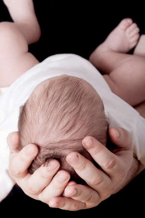 Newborn baby sleeping in father handsの写真素材