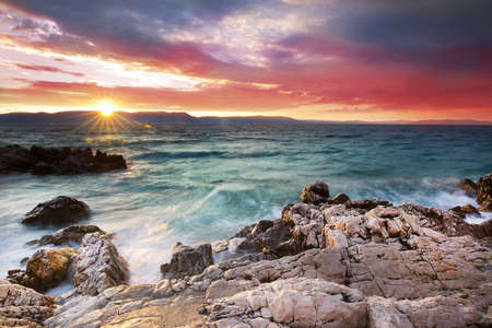Sunrise over the rocky beach on the coast of Adriatic Sea, Istria, Croatiaの写真素材