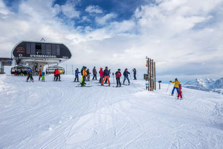 Skiers skiing in Kitzbuehel ski resort on the top of Steinbergkogrl, resort with 54 cable cars and 170 km prepared skiing slopes, place of famous hahnenkamm races, Tyrol, Austriaのeditorial素材