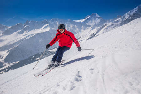 Young happy man skiing in Lenzerheide ski resort, Grisons, Switzerland.