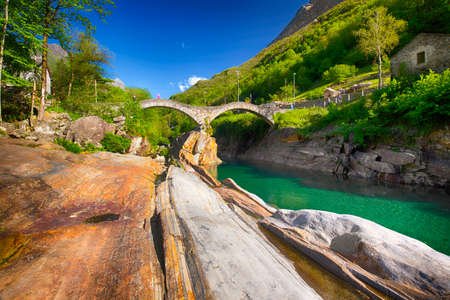 Double arch stone bridge at Ponte dei Salti with waterfall, Lavertezzo, Verzascatal, Canton Tessin.の写真素材