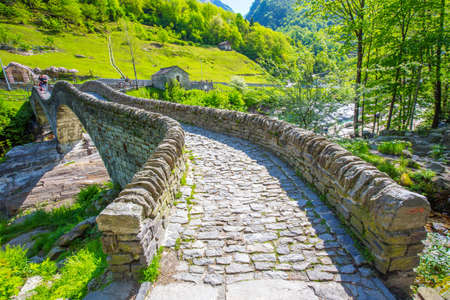 Double arch stone bridge at Ponte dei Salti with waterfall, Lavertezzo, Verzascatal, Canton Tessin.の写真素材