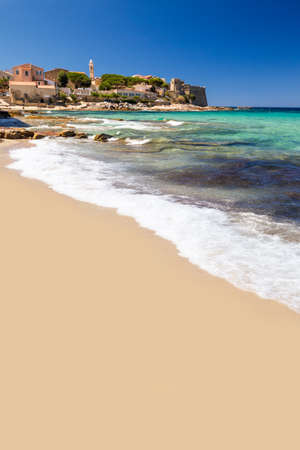 View to beautiful Algaloja old town and sandy beach with turquoise clear water, Corsica, France, Europe.の写真素材