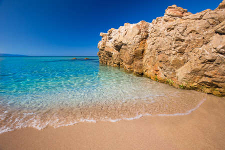 Beautiful sandy beach with rocks and tourquise clear water near Cargese, Corsica, France, Europe.の写真素材