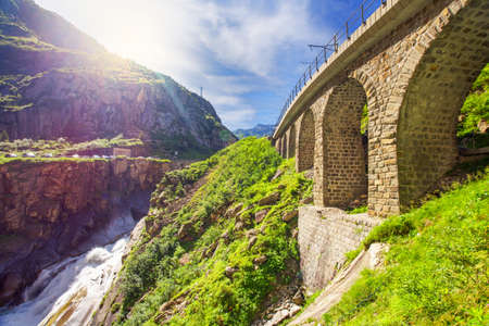 River Reuss flowing through the railroad bridge Teufelsbruecke - Devil's bridge.The Schollenen Gorge...