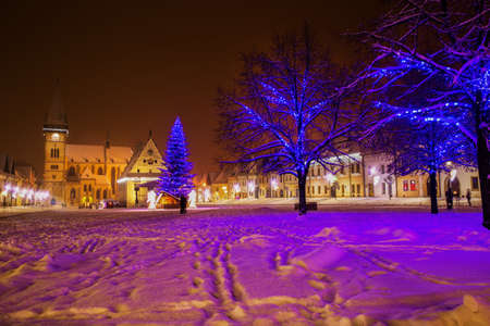 Christmas tree in old city center of Bardejov covered by fresh snow during Christmas holidays, Slovakia, Europe.の写真素材