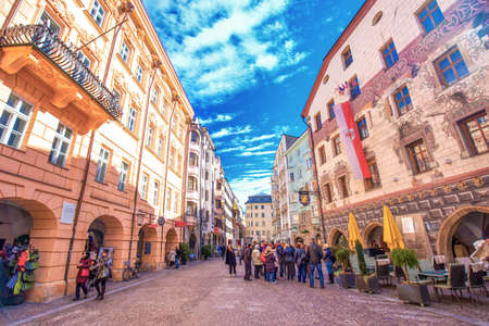 INNSBRUCK, AUSTRIA - March 11, 2017 - People in Innsbruck city center with typical colorful houses. It is capital city of Tyrol in western Austria, Europe.のeditorial素材