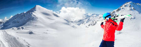 Man enjoying the stunning view before skiing in famous ski resort in Tyrolian Alps, Zillertal, Austriaの写真素材
