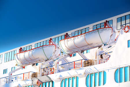 Lifeboats on a luxurious cruise ship.