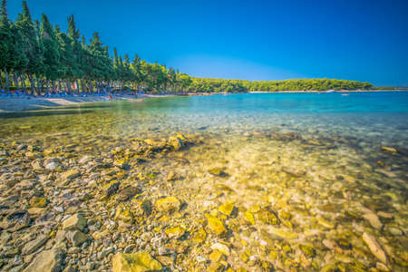 Beach in Supetar town on Brac island with turquoise clear water, Supetar, Brac, Croatia, Europe.
