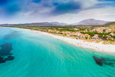 Graniro beach with azure clear water and La Caletta town, Sardinia, Italy, Europe.の写真素材
