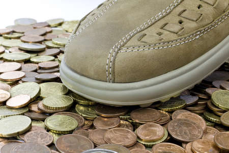 light brown leather shoe walking on euro coinsの写真素材