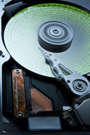 open rotating hard disk with rotating platter and moving head. Green data on platter