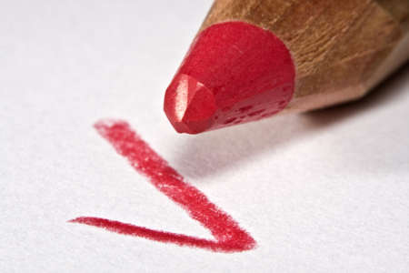 Red pencil with check mark on paper, macroの写真素材