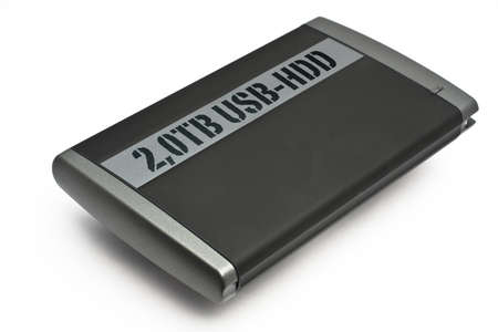USB Hard Disk drive with 2TB of space. Grey Enclosure on white Background with Shadowの写真素材