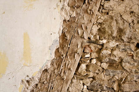 Old wall construction with wood, stone and renderの写真素材