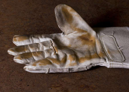 used working glove with brown backgroundの写真素材