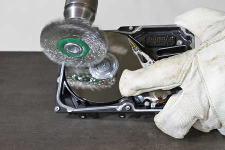cleaning data from open hard drive with electrical steel brush