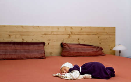 nursling alone in huge bed. copy space for textin and over the bedの写真素材