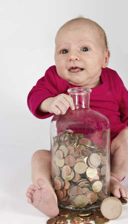 nursling with money in bottle looking at cameraの写真素材