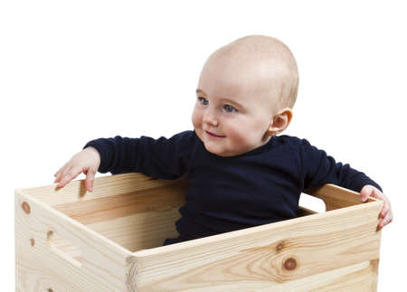 single toddler in wooden box looking to the left.の写真素材