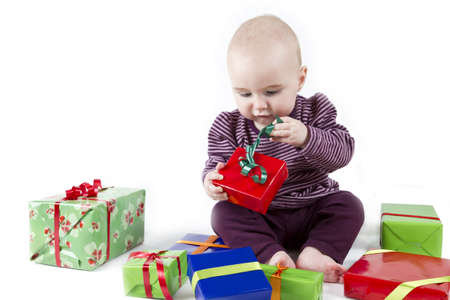 young child unpacking presents. white backgroundの写真素材