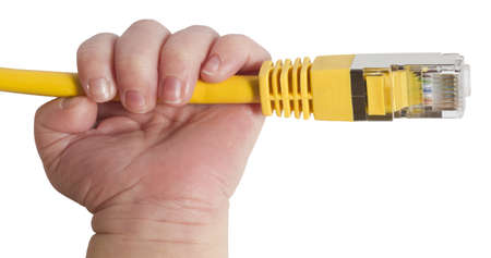 baby hand holding yellow network plug in white backgroundの写真素材