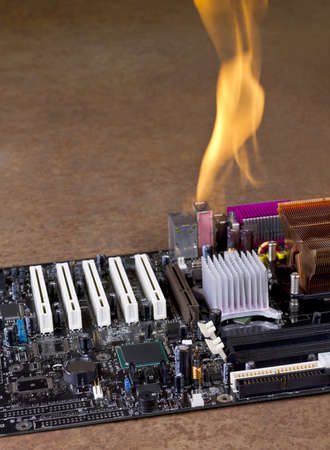 burning computer mainboard in rusty backgroundの写真素材