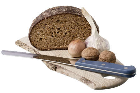 brown bread on shelf with onion, garlic and walnut  isolated on white backgroundの写真素材