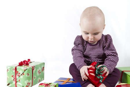 young child unpacking presents. white backgroundの写真素材