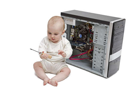 young child with screwdriver in hand working on open computer in white background.