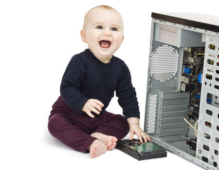 young child in blue shirt with open computer on white backgroundの写真素材