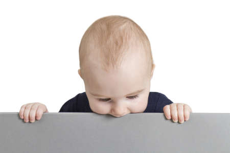 young baby holding blank grey cardboard. isolate on white backgroundの写真素材