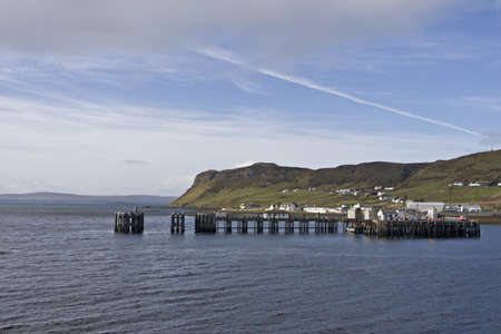 scottish coast with peer and hills in backgroundの写真素材