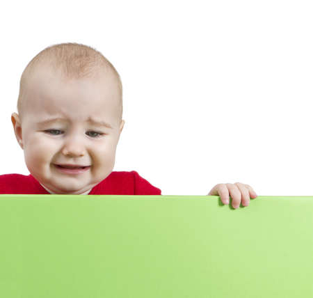 sad young child holding shield. isolate on white backgroundの写真素材