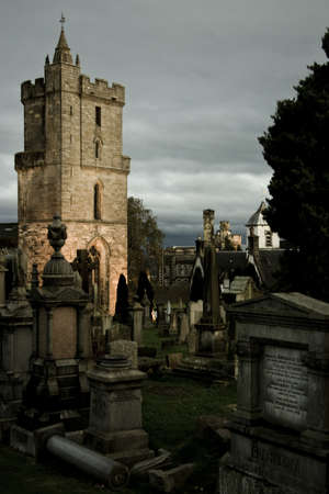 mystic cemetery in stirling with illuminated tower in backgroundのeditorial素材
