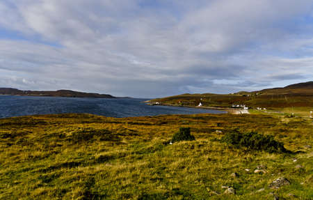 rural scottish scene at the coast with wetland and cloudy skyの写真素材