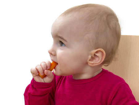 child in red shirt eating  white background