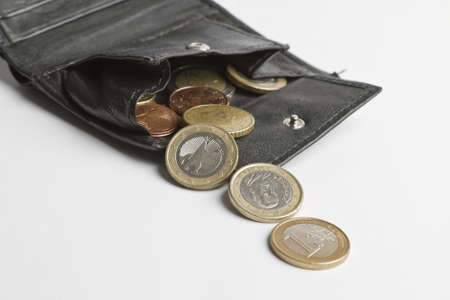 loose cash falling out of black wallet in white backgroundの写真素材