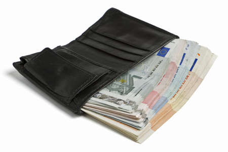 many banknotes in black wallet on light backgroundの写真素材
