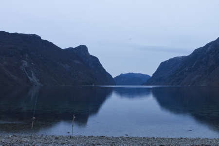 evening view over fjord in norway with cloudy sky and steep coastの写真素材