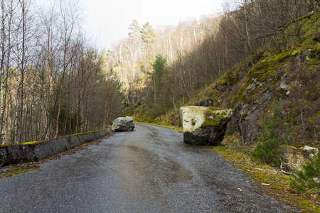 unused, run-down road in rural landscape - norwayの写真素材