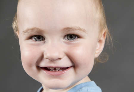 portrait of young child on grey backgroundの写真素材